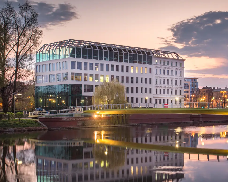 Modern conference venue by the river at sunset